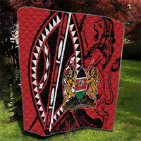 Red quilt with black and white geometric pattern and Harambe shield crest