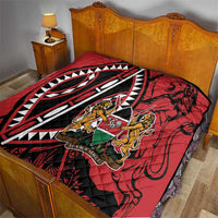 Red quilt on bed with black-and-white pattern and Harambe shield crest