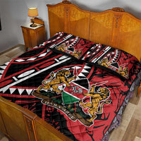 Red, black and white quilt bed set with animal and shield motifs, shown with two pillows