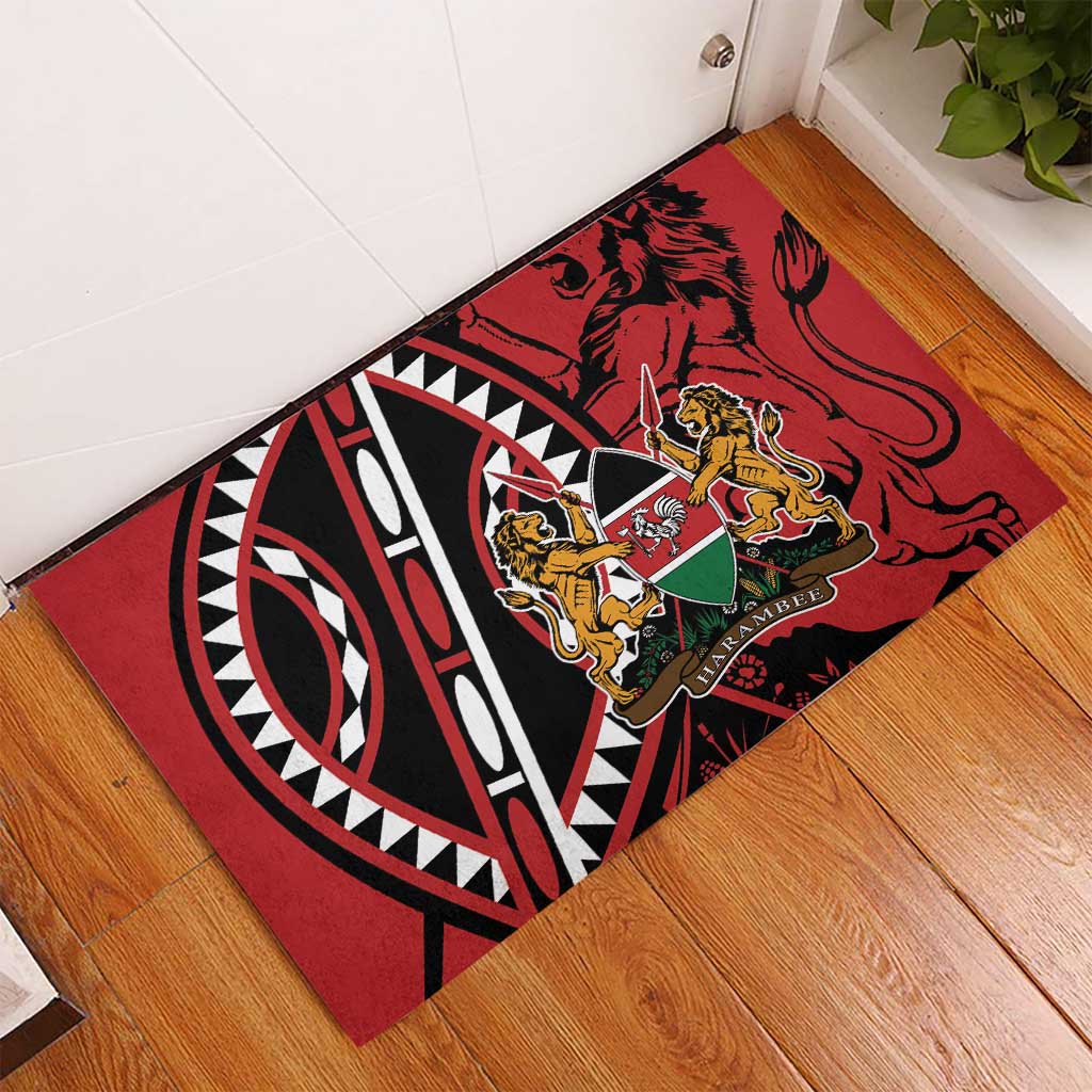 Red rubber doormat laid on wood floor with lion shield and tribal patterns