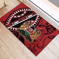 Red rubber doormat corner view with lion shield crest and black-and-white motif