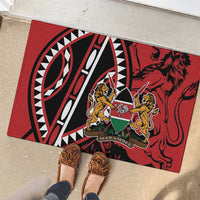 Red rubber doormat in sun with lion shield crest and black-and-white circular pattern