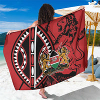 Red African shield sarong draped wide, featuring lion crest and circular emblem