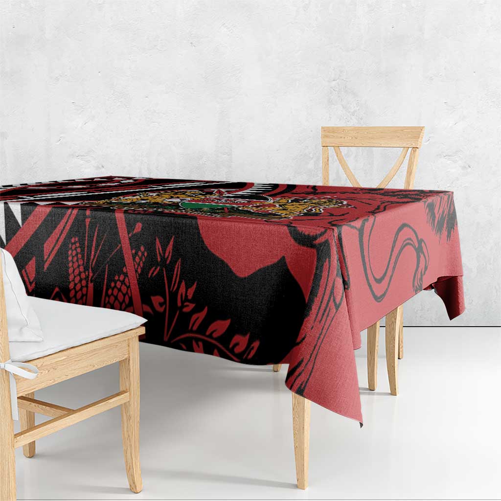 Red, black and white graphic tablecloth with crest, draped over dining table