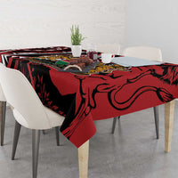 Red and black African shield tablecloth with lion emblem on dining table