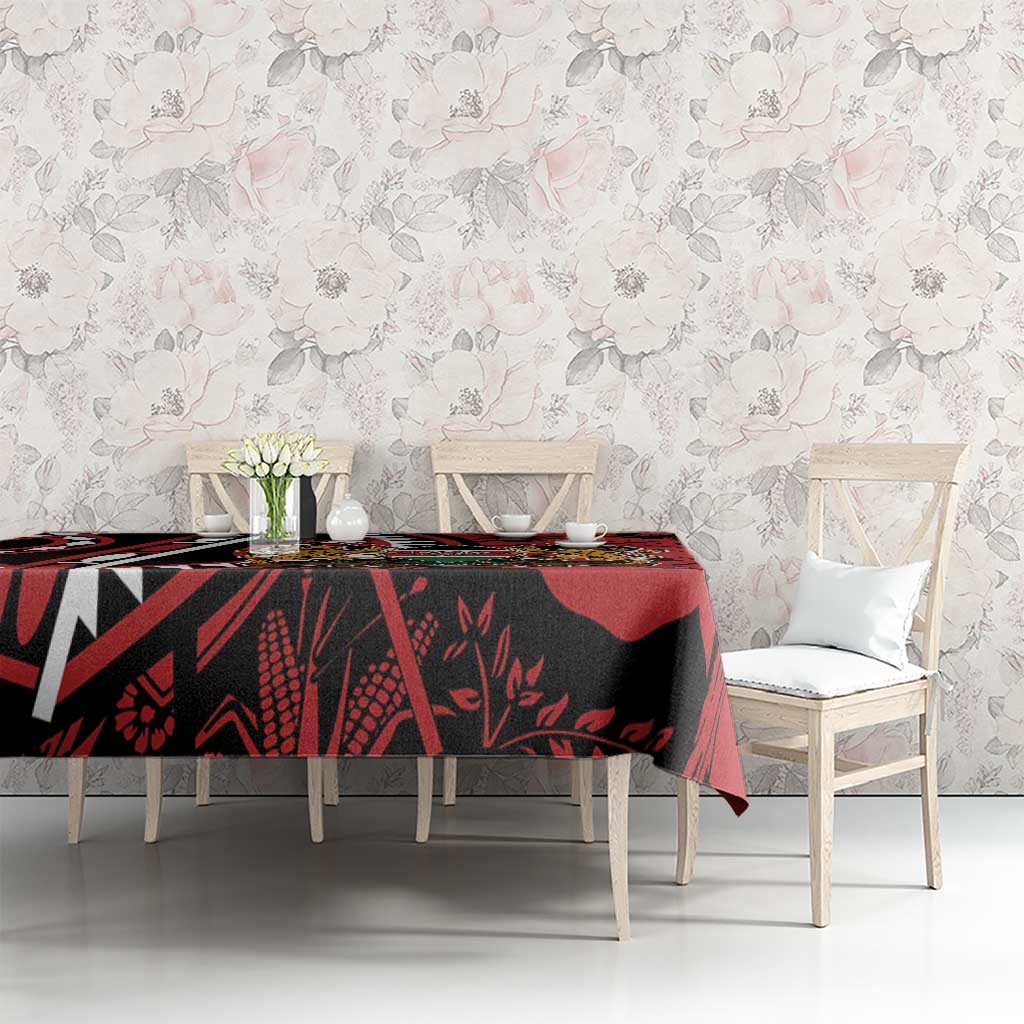 Red and black African shield tablecloth with lion crest on dining table