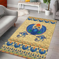 Rectangular beige area rug with blue scarab beetle center and patterned border