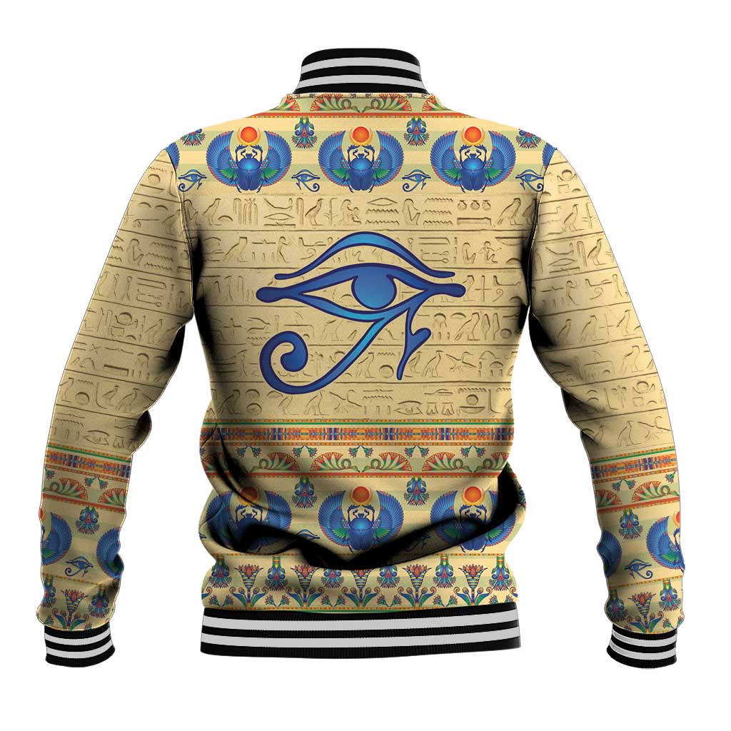 Beige baseball jacket with large blue eye and hieroglyph pattern, black-and-white striped collar