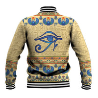 Beige baseball jacket with large blue eye and hieroglyph pattern, black-and-white striped collar
