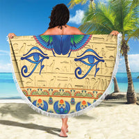 Beige round beach blanket with fringe edge, blue winged scarab design with ornate band