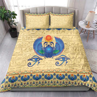 Beige duvet and pillowcases featuring blue scarab beetle sun emblem and ornate border