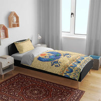 Beige duvet cover and pillowcases with blue scarab beetle emblem and blue decorative border