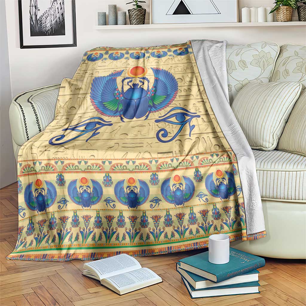 Scarab beetle themed blanket in beige with blue and teal winged scarab and border
