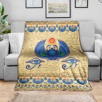 Beige scarab beetle blanket on sofa, blue winged scarab graphic with patterned border