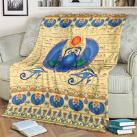 Beige scarab beetle blanket close view with blue winged scarab, gold patterns, and trim