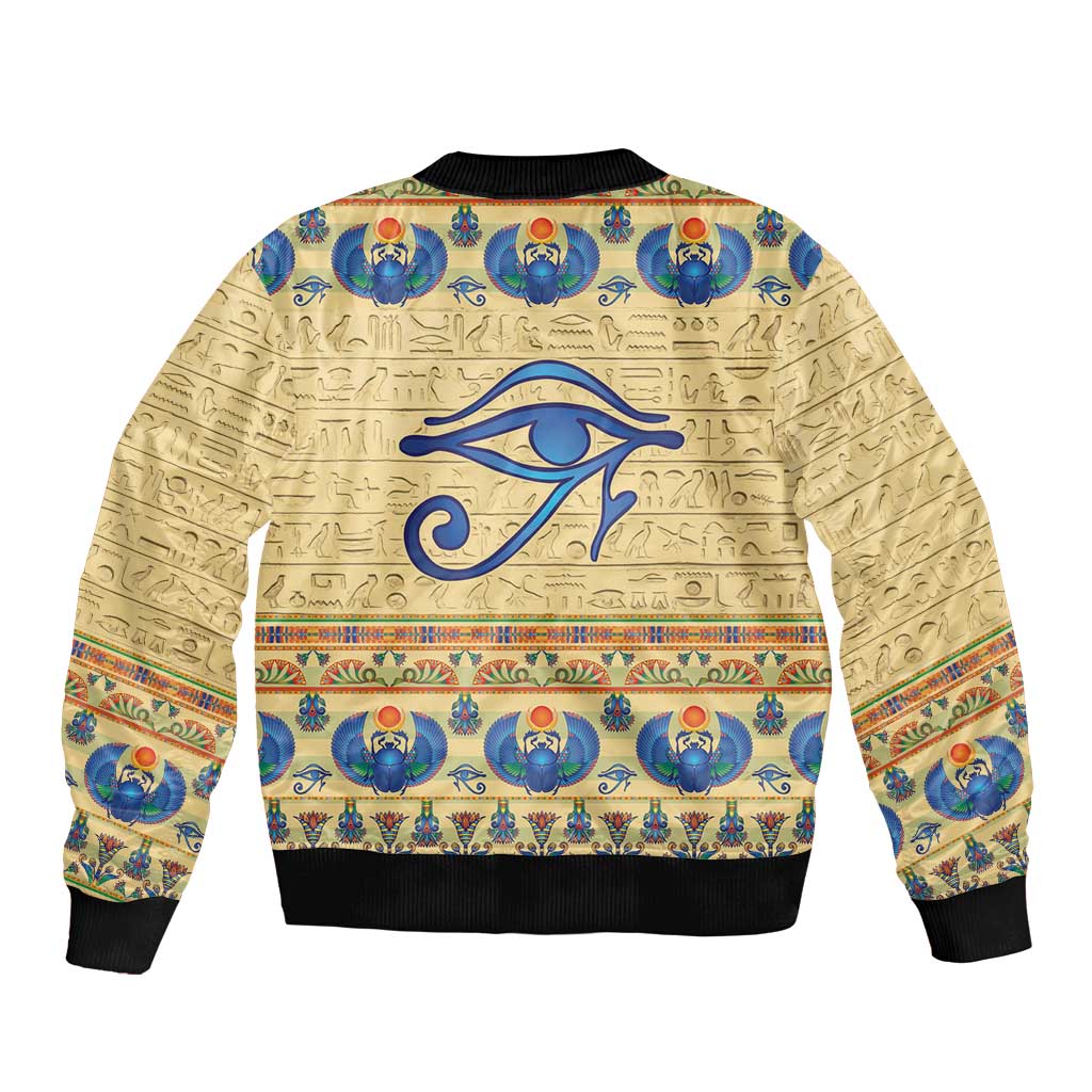 Beige bomber jacket with Egyptian scarab and hieroglyph print, ribbed hem and cuffs