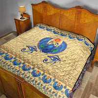Beige bedspread quilt with blue winged scarab beetle center and patterned edge trim