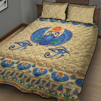 Beige quilt with central blue scarab beetle motif, decorative blue border, and 2 pillows