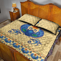 Beige quilt bed set with blue scarab beetle motif and two matching pillows on a bed