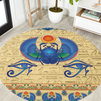 Beige round carpet rug with blue scarab beetle and Egyptian hieroglyph pattern