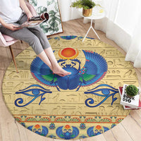 Beige round carpet rug featuring a blue winged scarab beetle center design
