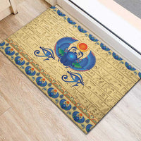 Beige rubber doormat with central blue scarab beetle, sun disk above, ornate blue border
