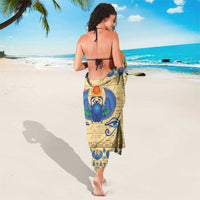 Beige Egyptian scarab beetle sarong, tied at waist; blue center motif and border