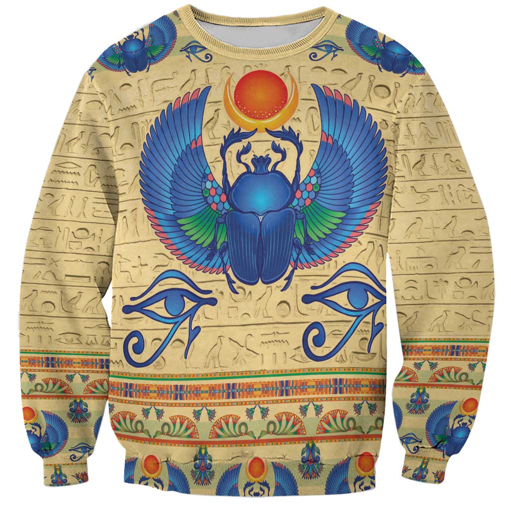 Beige sweatshirt with colorful Egyptian scarab beetle graphic and hieroglyph patterns
