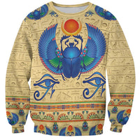 Beige sweatshirt with colorful Egyptian scarab beetle graphic and hieroglyph patterns