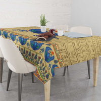 Beige tablecloth with blue Egyptian motifs and centered scarab beetle on dining table