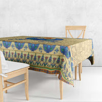 Beige tablecloth with blue Egyptian symbols and border, draped over dining table