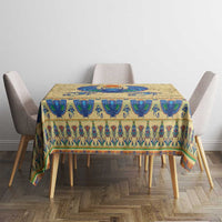 Beige tablecloth with blue scarab beetle and ornate Egyptian pattern on dining table