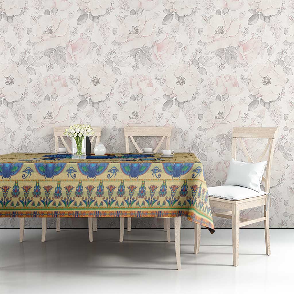 Beige tablecloth with blue hieroglyphs and colorful Egyptian motif border on table