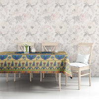 Beige tablecloth with blue hieroglyphs and colorful Egyptian motif border on table
