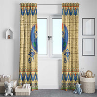 Beige window curtain panels with blue winged scarab, hieroglyphs, and teal border