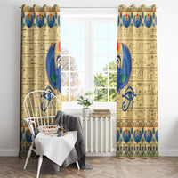 Beige curtain panels with tall blue winged scarab motif and colorful Egyptian border