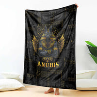 Folded black throw blanket with gold Anubis face and wing rays