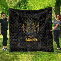 Black Anubis quilt with quilted diamond texture, large golden Anubis centerpiece, 'ANUBIS' label.