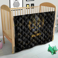 Black quilt with quilted diamond pattern, golden Anubis head and wings, 'ANUBIS' lettering.