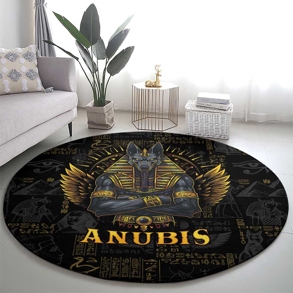 Black round Anubis rug with gold winged figure, “ANUBIS” title, and hieroglyph motifs