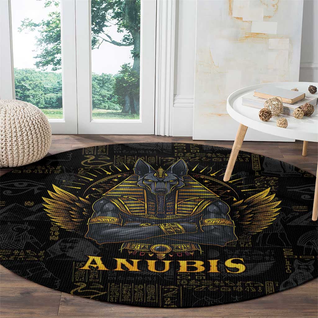 Black round Anubis rug with gold seated figure and “ANUBIS” text, hieroglyph border