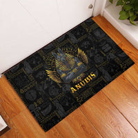 Black rubber doormat featuring Anubis medallion graphic, gold lettering at center