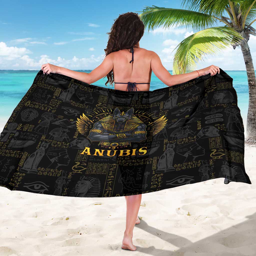 Black Anubis sarong held open, showing gold winged Anubis portrait and text