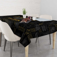 Black tablecloth with gold Egyptian symbols and motifs across the tabletop