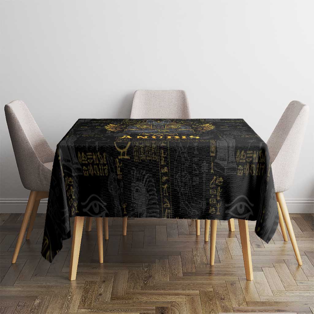 Black Egyptian motif tablecloth on a dining table with draped corners
