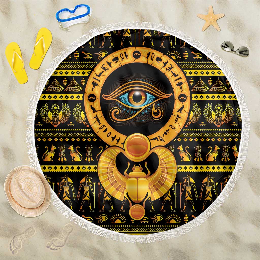 Round Eye of Ra beach blanket with white fringe and gold sun-eye design on black