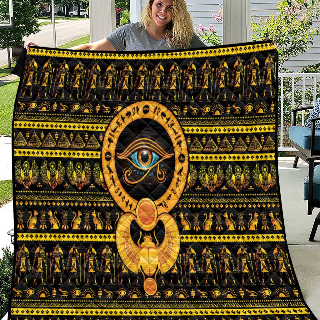 Black Eye of Ra quilt with gold patterns and large central eye emblem design