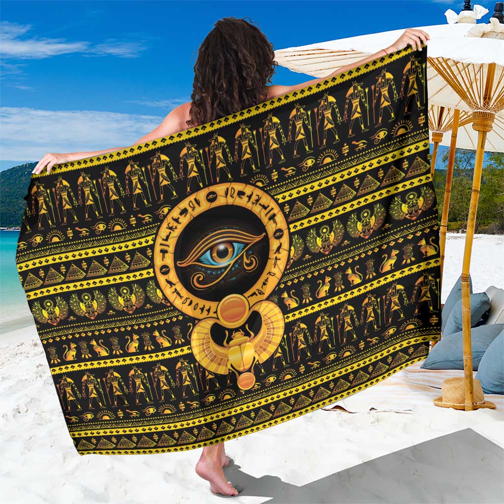 Black sarong with gold Eye of Ra and hieroglyph border, held up for display