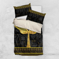 Black bedding set with gold ankh on duvet; included pillowcases shown folded on top