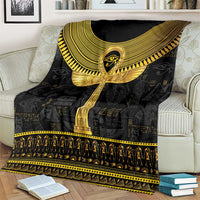 Black Egyptian ankh hieroglyph blanket draped over sofa with gold winged emblem and border